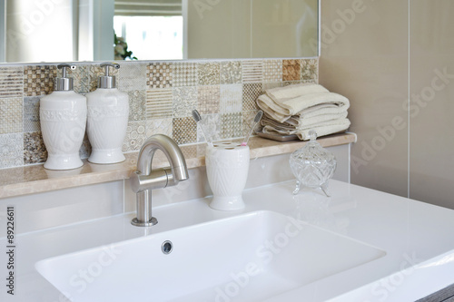 washbasin with faucet and liquid soap bottle at home