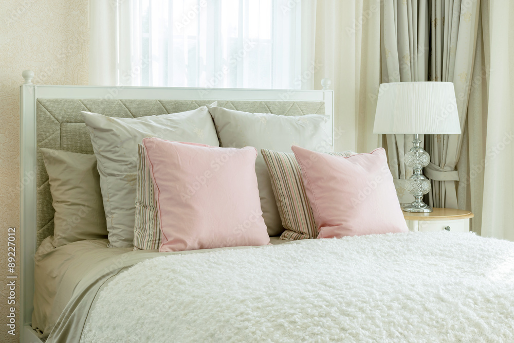 luxury bedroom interior with pink pillows and reading lamp on be luxury bedroom interior with pink pillows and reading lamp on be