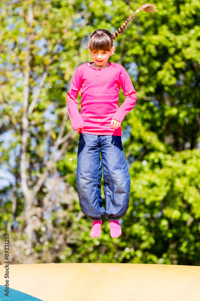 Happy girl on trampoline