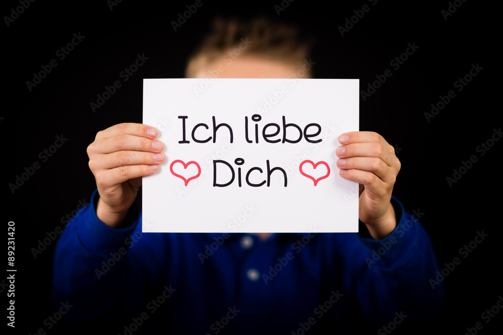 Child holding sign with German words Ich liebe Dich - I Love You Child holding sign with German words Ich liebe Dich - I Love You
