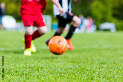 Blurred kids playing youth football match