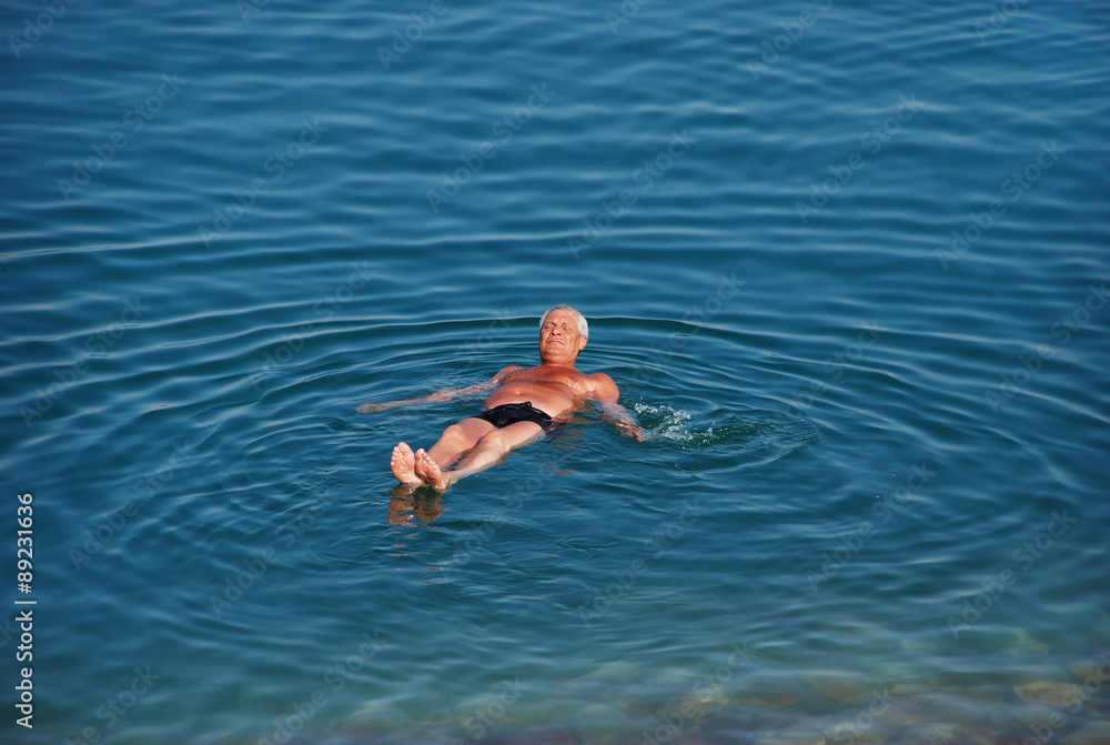 Man swims in Dead Sea