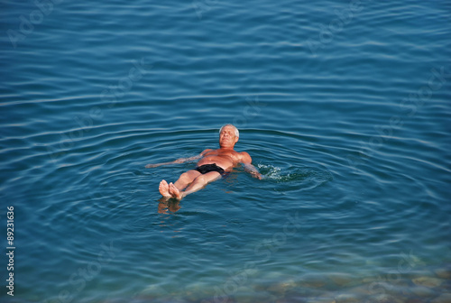Man swims in Dead Sea