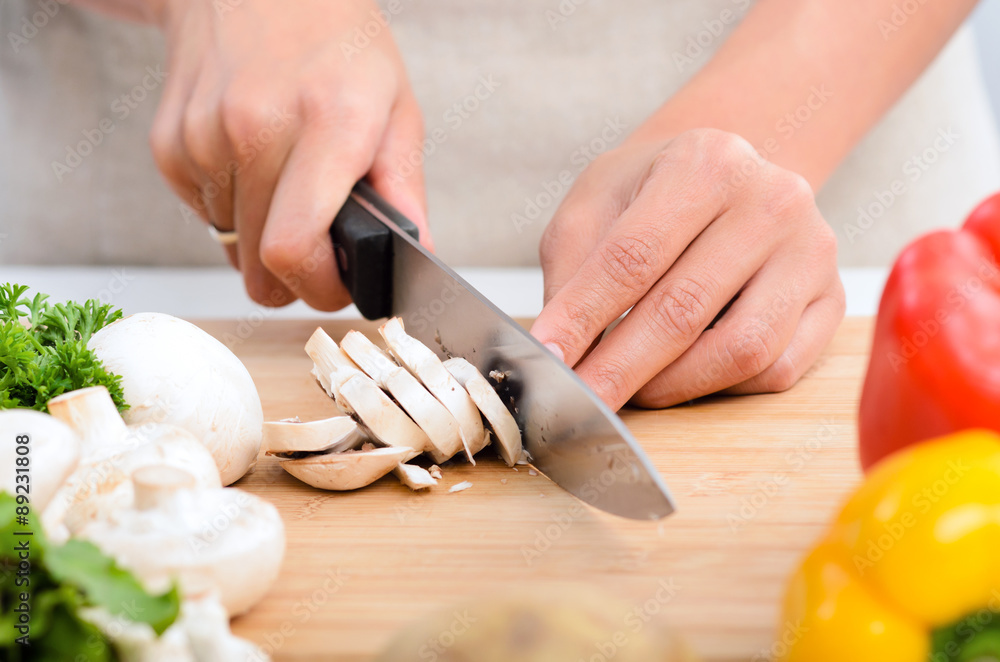 Close up of hands slicing vegetables with knife Close up of hands slicing vegetables with knife