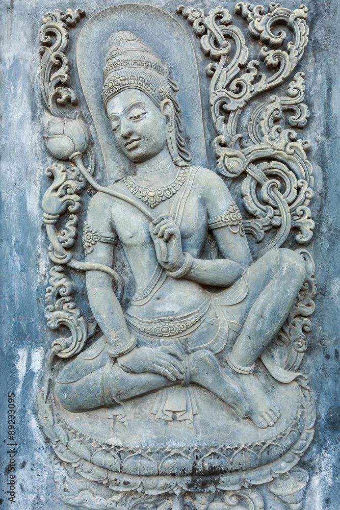 woman statue on the wall in temple , Thailand
