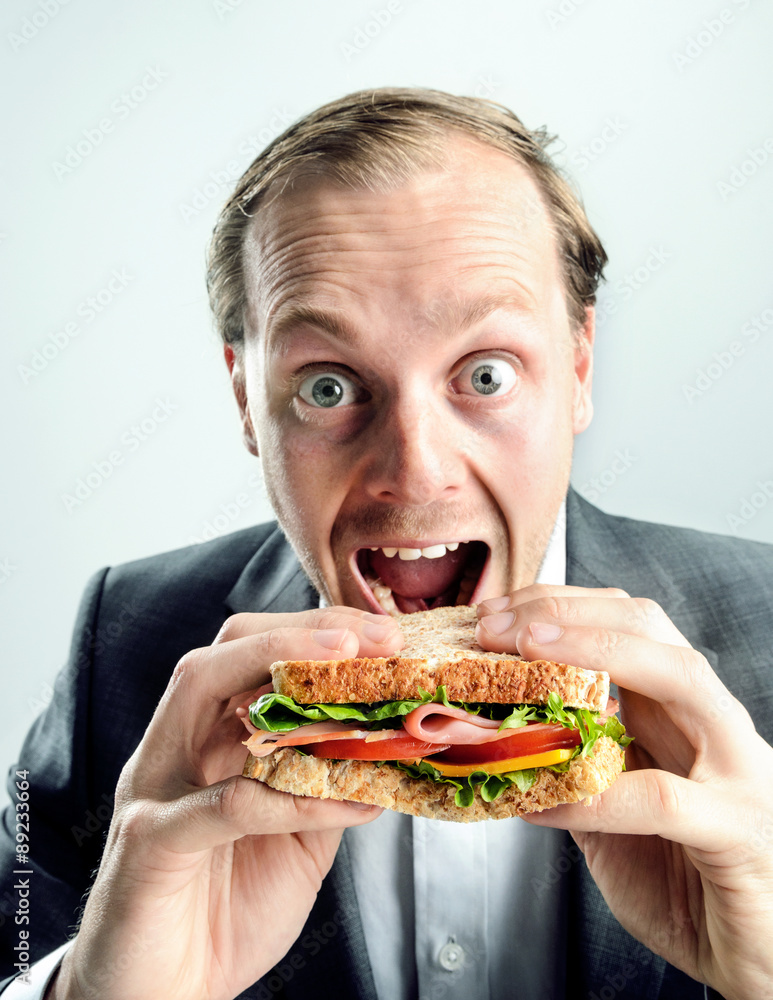 Funny business man eating sandwich Funny business man eating sandwich