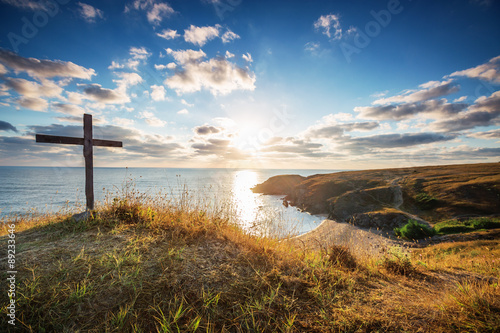 Christian cross on a wild beach with a wonderful sunrise © ValentinValkov