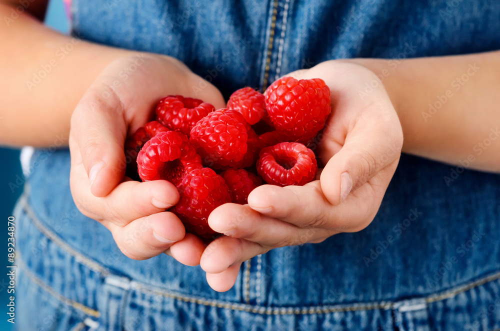 Holding raspberries in her hand Holding raspberries in her hand