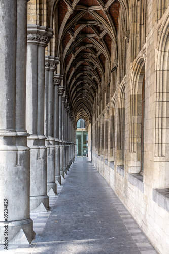 Fotografering Walking through an archway in Mechelen Belgium