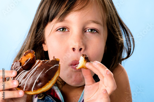 Happy kid eating a doughnut