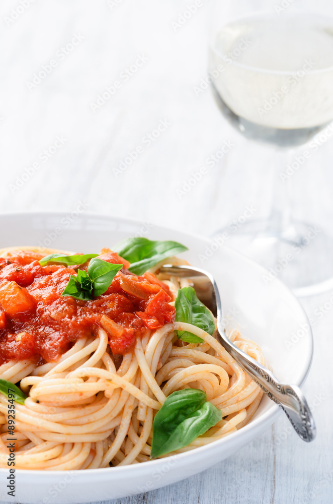 Spaghetti with red tomato sauce and basil garnish Spaghetti with red tomato sauce and basil garnish