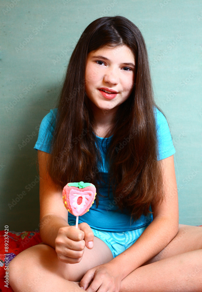 Preteen Beautiful Girl With Strawberry Candy On Stick Stock