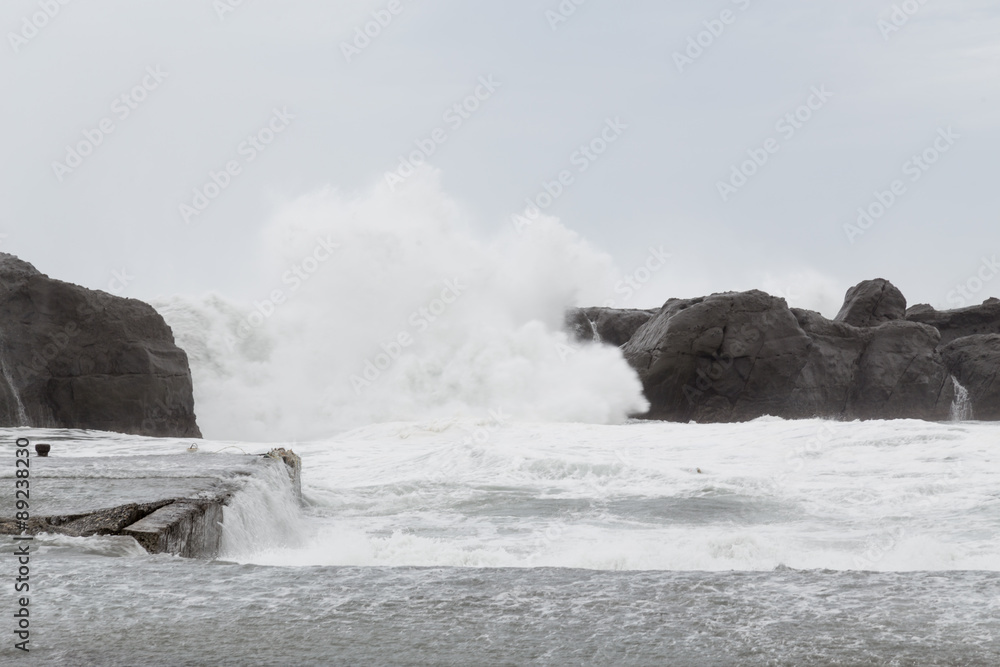 Stormy sea with waves crashing on rocks Stormy sea with waves crashing on rocks