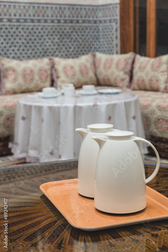 Two white jugs on the wooden table in Moroccan house
