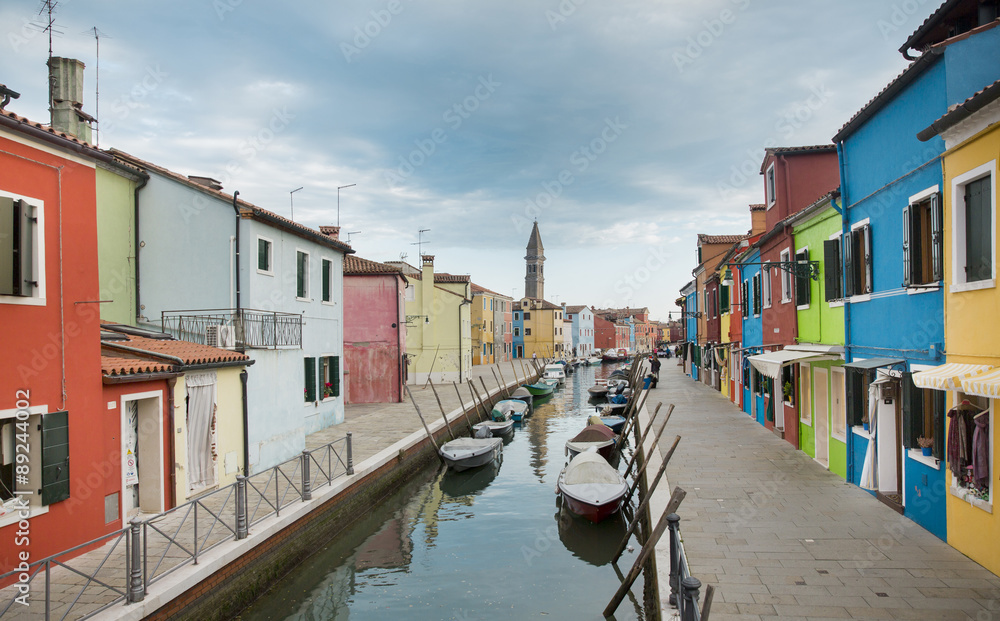 Burano island in Venice with colorful houses and boats, Italy