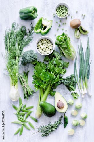 Green vegetables on white rustic background