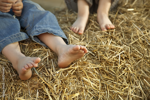 children's feet in the hay
