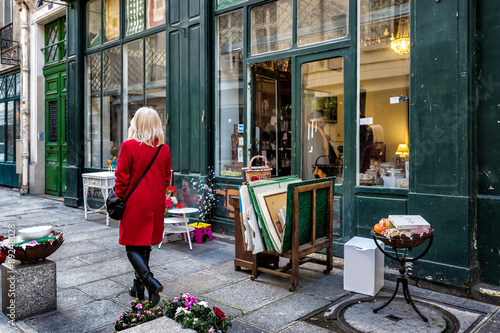 Paris street antique shop sidewalk shopper in red coat