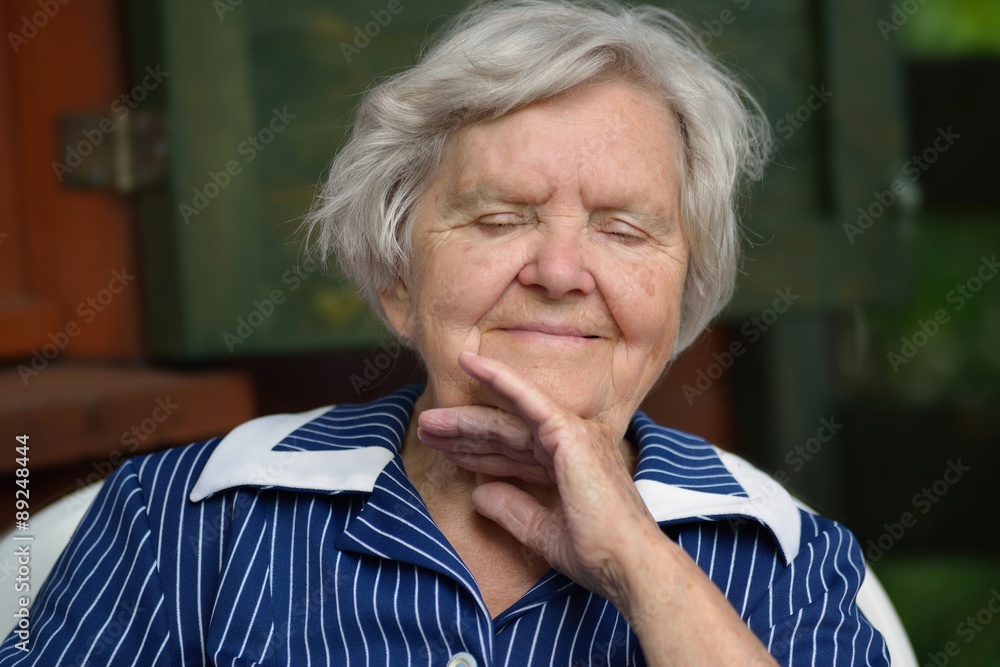 Senior woman smiling and dreaming in garden. Senior woman smiling and dreaming in garden.
