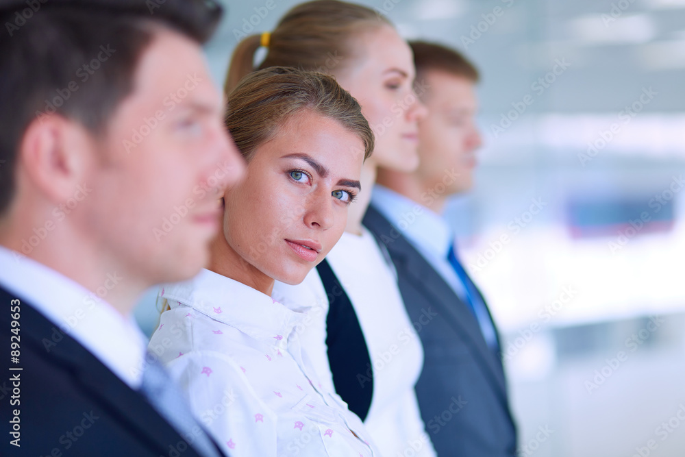 Smiling successful business team standing in office Smiling successful business team standing in office