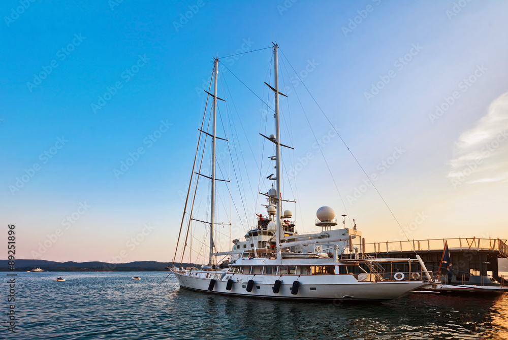 Yacht in marina at sunset.