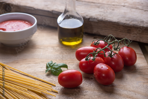 Ingredients for a typical italian lunch lying on a wooden table