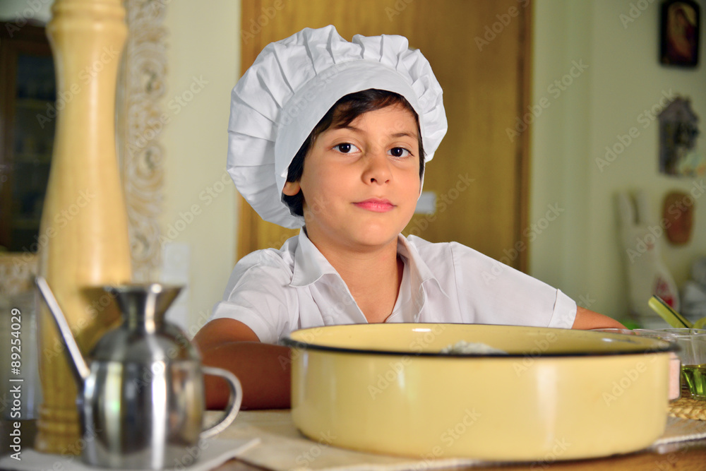 Little chef cook in the home kitchen