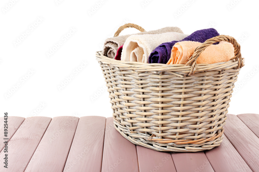 Obraz premium Colorful towels in basket isolated on white