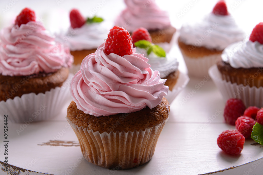 Delicious cupcakes with berries on table close up