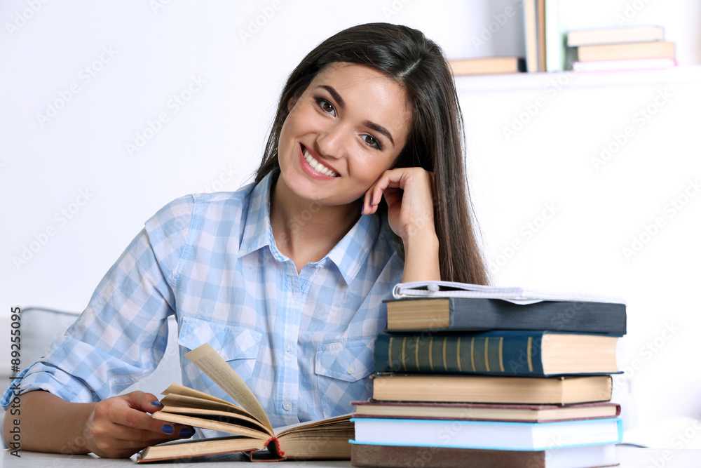 Young girl reading book in room Young girl reading book in room