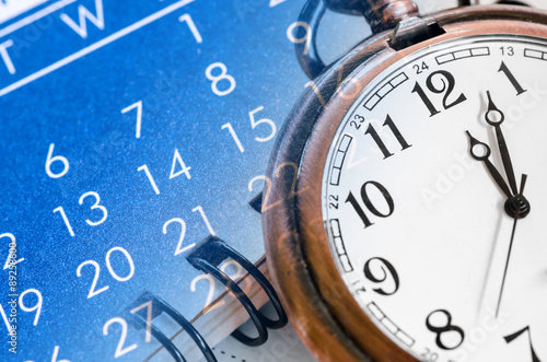 Pocket watch and blue calendar.