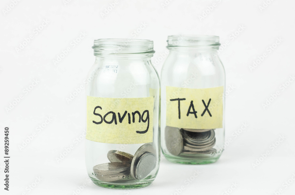 Jar for savings and taxes full of coins. Jar for savings and taxes full of coins.