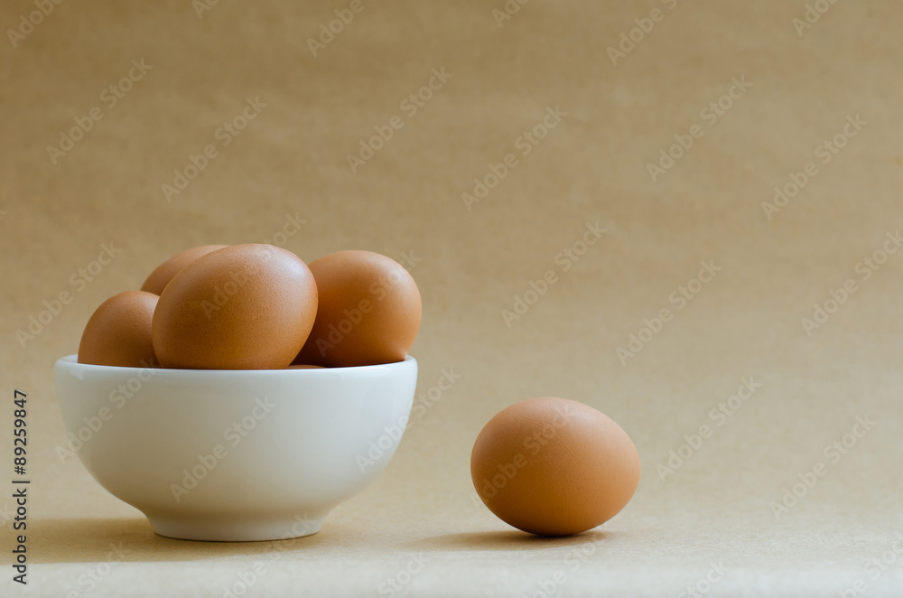 Eggs In White Bowl On Brown Background. Eggs In White Bowl On Brown Background.