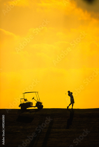 Silhouette of a man during a golf swing