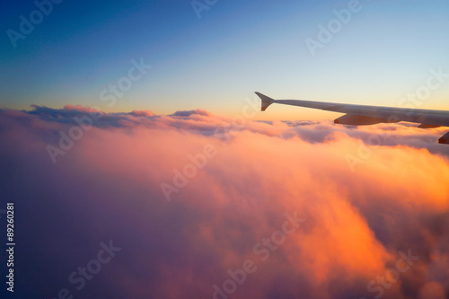 Airplane Wing in Flight from window, sunset sky