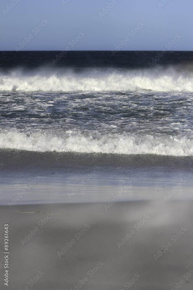 Waves breaking on the shore Bertha's Beach. Falkland Islands.