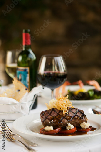 Steak dinner on white plate.