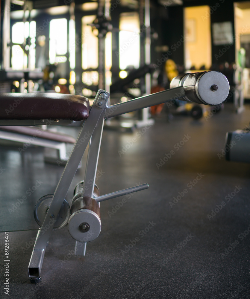 Weight lifting trainer in modern gym Weight lifting trainer in modern gym