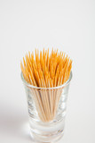 Toothpick in the glass on white paper background