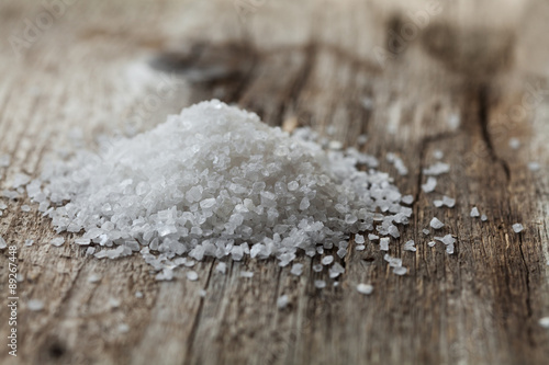 Sea salt on rustic wooden background