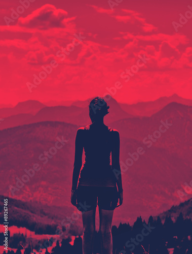 Woman enjoying a dramatic red sunset