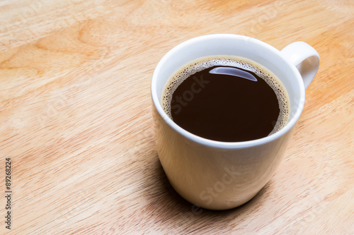 Cup of coffee on wooden table.