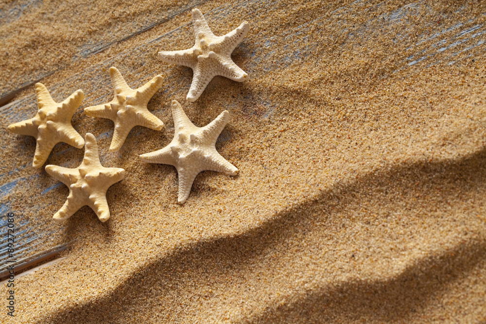 Starfishes on sand and planks Starfishes on sand and planks