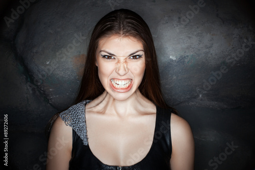 Tableau sur toile Portrait girl with grimace of anger on his face.