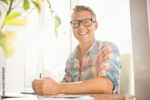 Smiling casual designer working with digitizer
