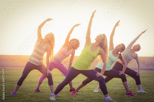 Sporty women warming up during fitness class