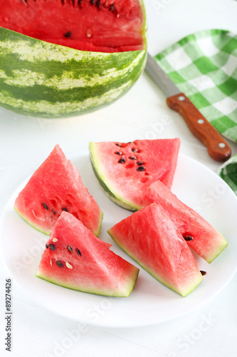 Tasty slice of watermelon on white wooden background