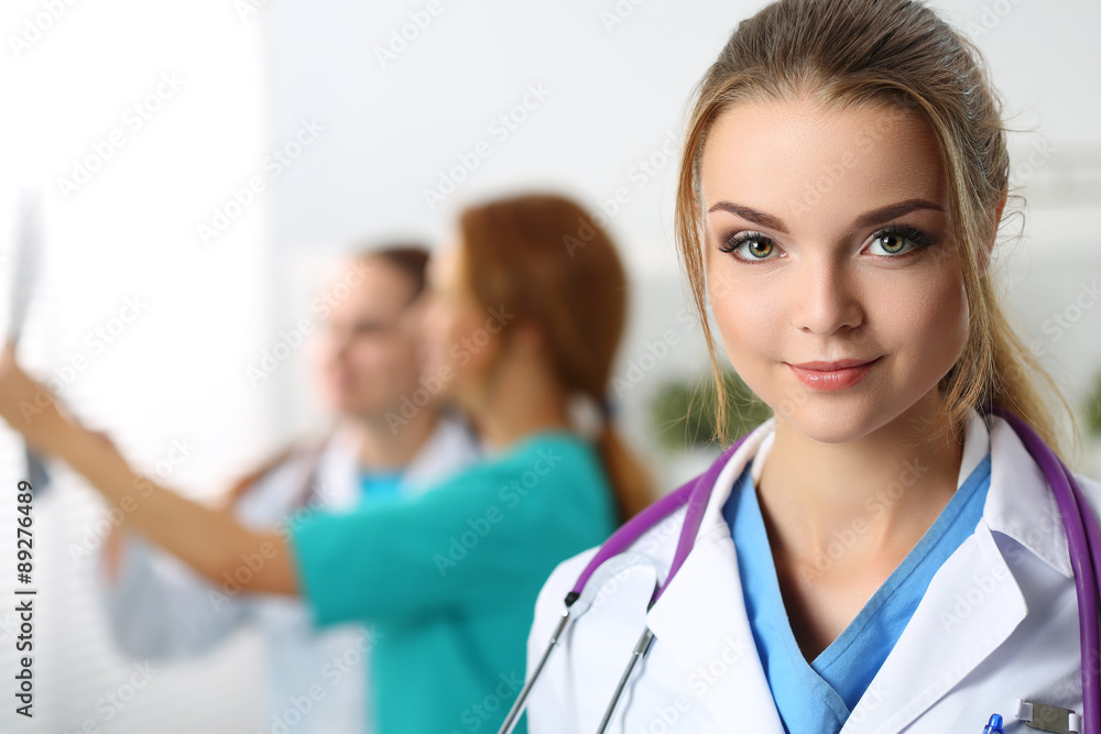 Beautiful smiling female medicine doctor looking in camera Beautiful smiling female medicine doctor looking in camera