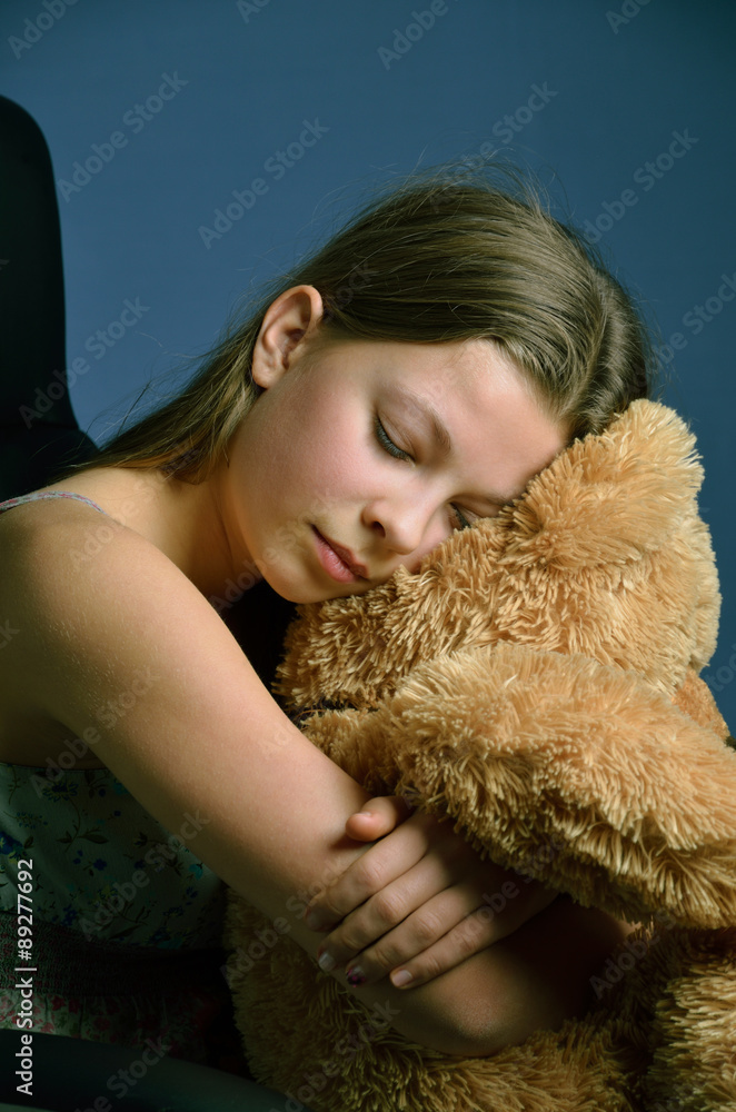Teenage girl with a teddy bear