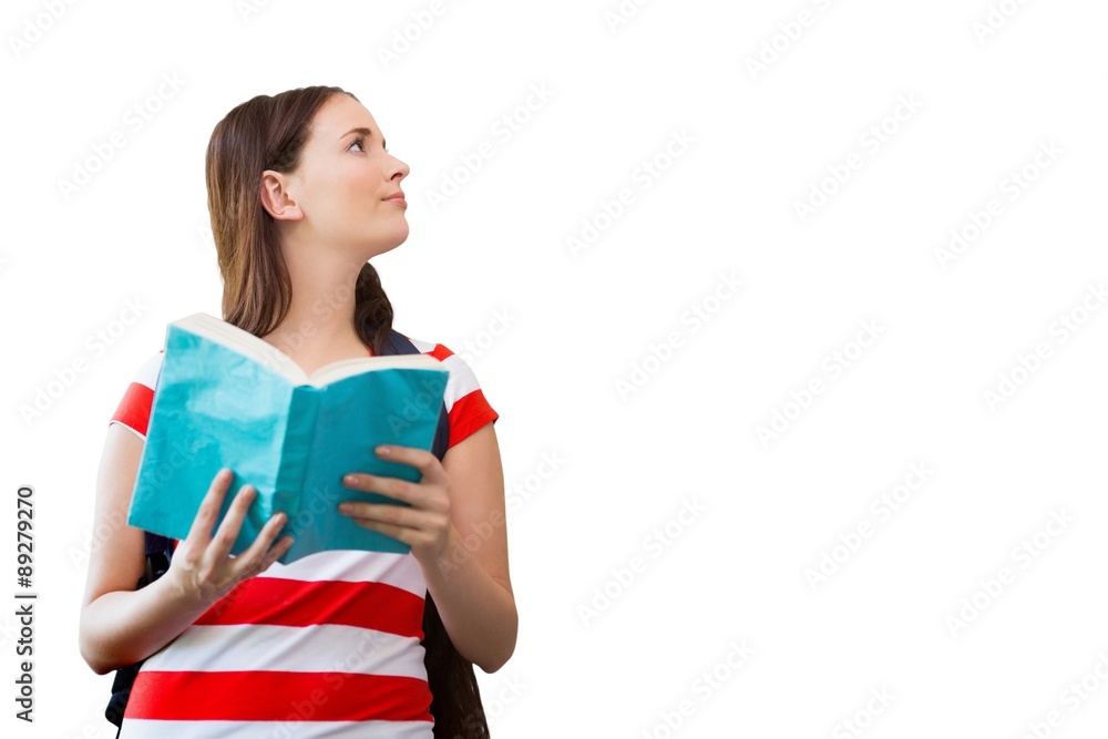 Composite image of student reading book in library Composite image of student reading book in library